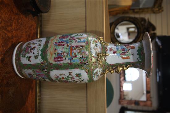 A large Chinese Canton-decorated famille rose baluster vase, 19th century, height 63cm, wood stand